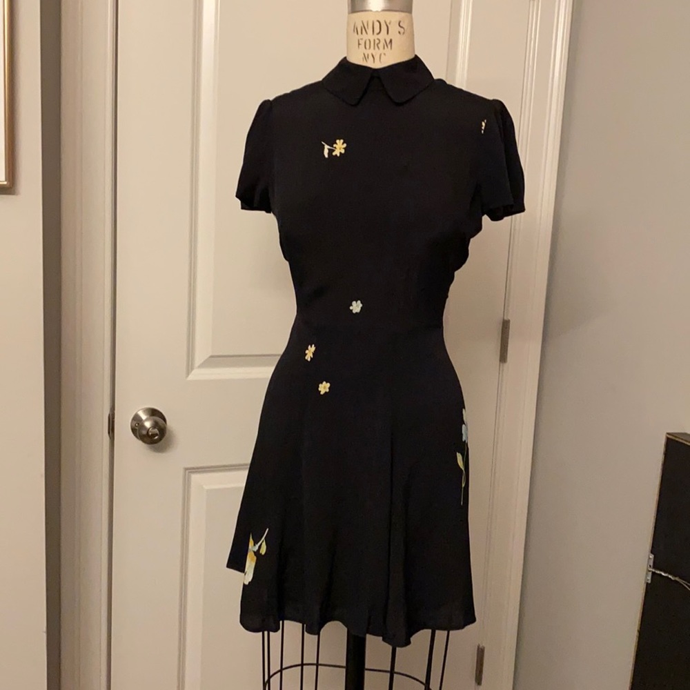 Reformation dress with collar and puff sleeves. Black with flower print.